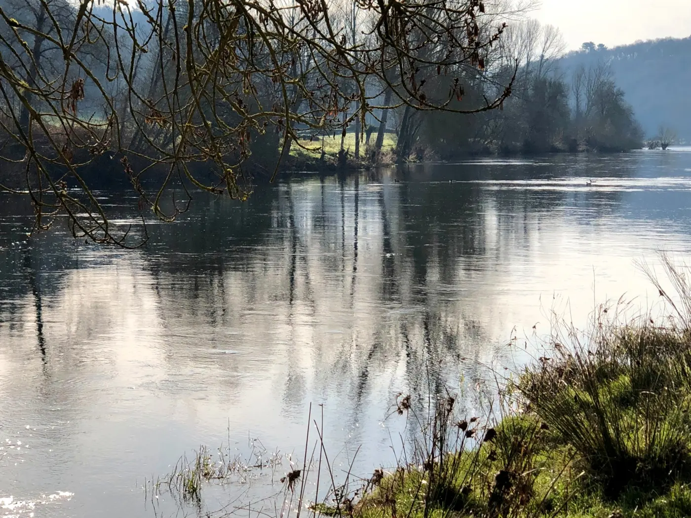 Clouds reflected in still river water
